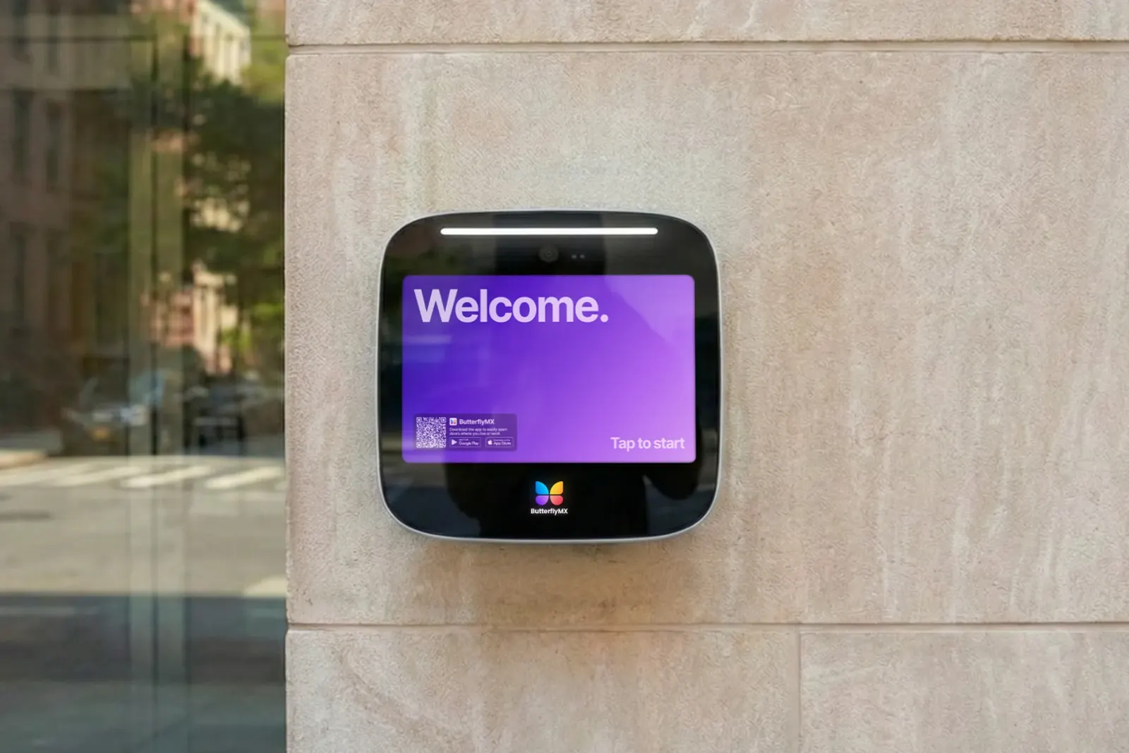 ButterflyMX 12-inch surface-mount video intercom on a limestone wall