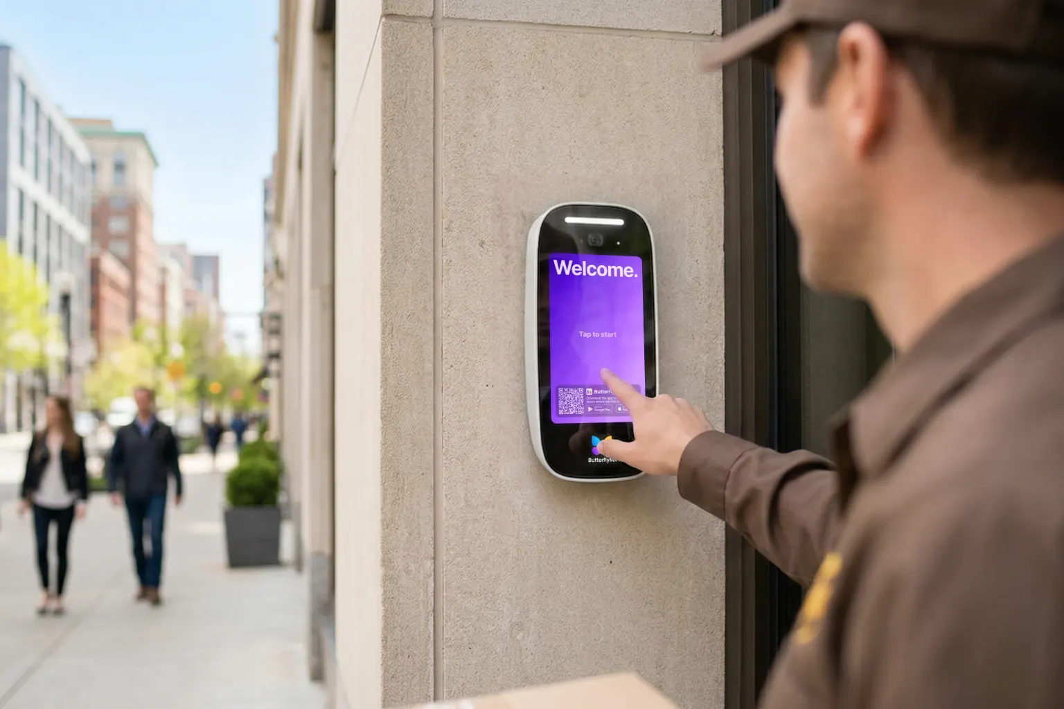 A courier taps the ButterflyMX delivery screen at a city building