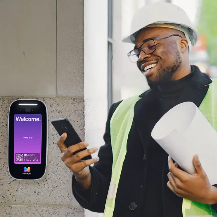 A construction manager at a new building entrance with a ButterflyMX intercom