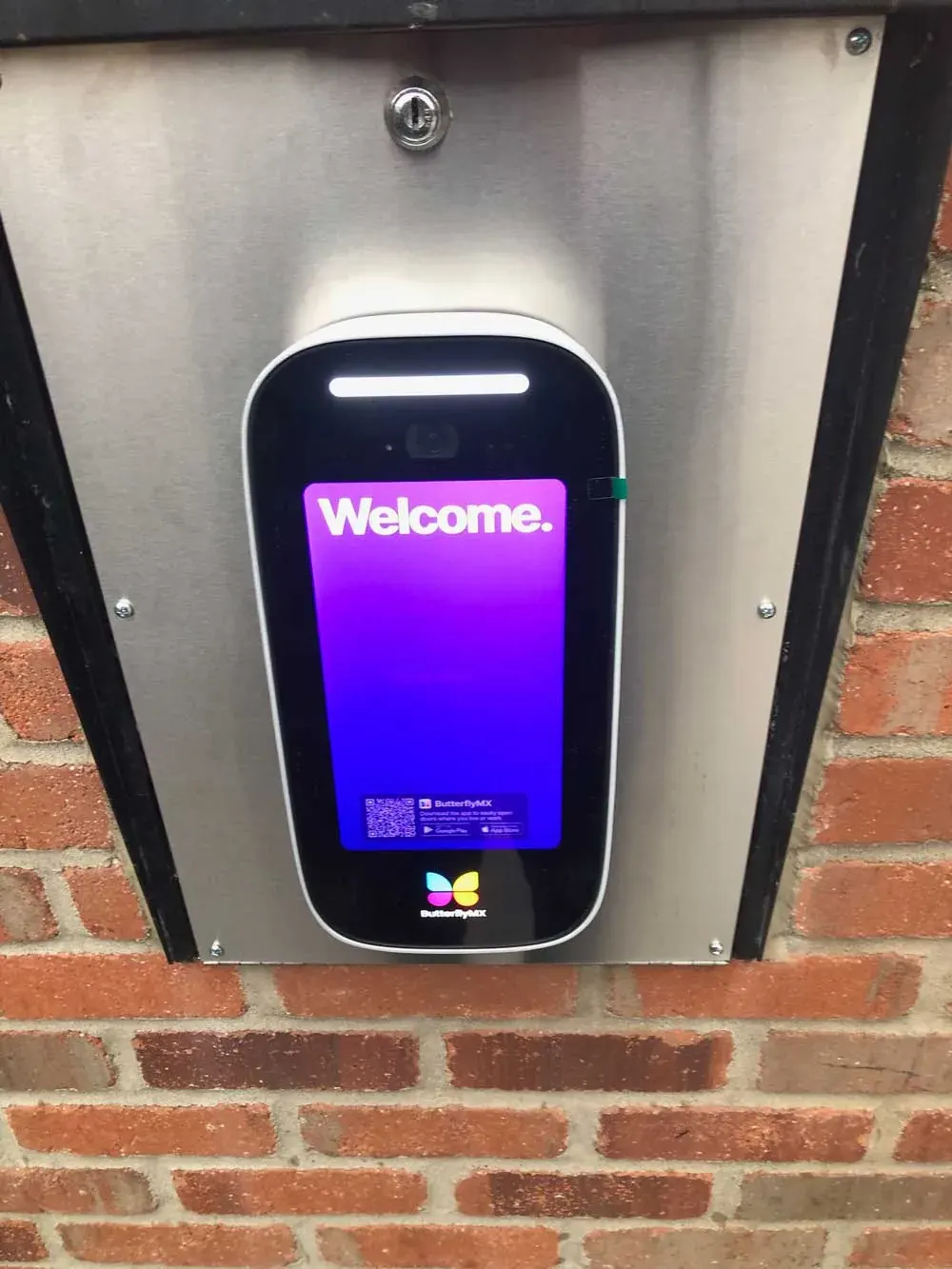 ButterflyMX intercom on a stone entry wall