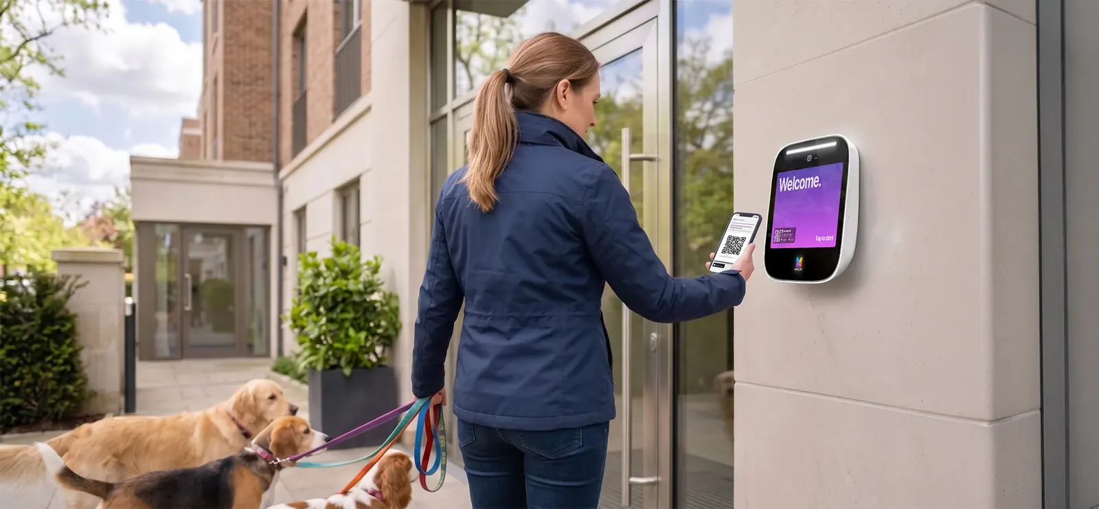 A resident with two dogs opens a condo building door using the ButterflyMX app